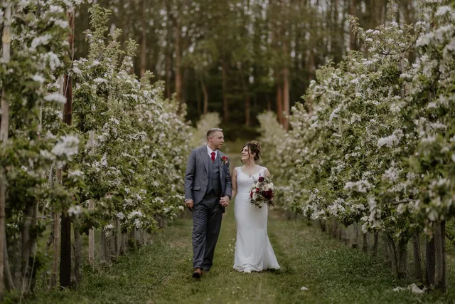 A bride and her father among the blossom