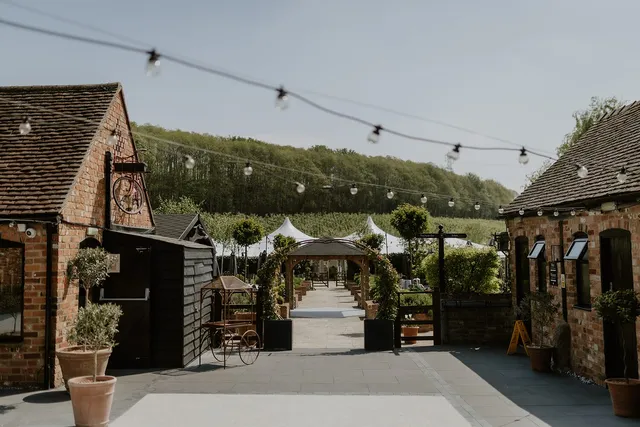 The pergola walk with the marquees beyond