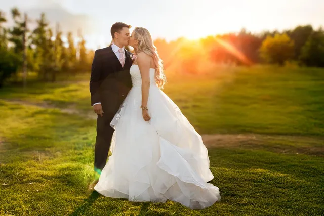 A couple in the sunset light with the veil catching the sun