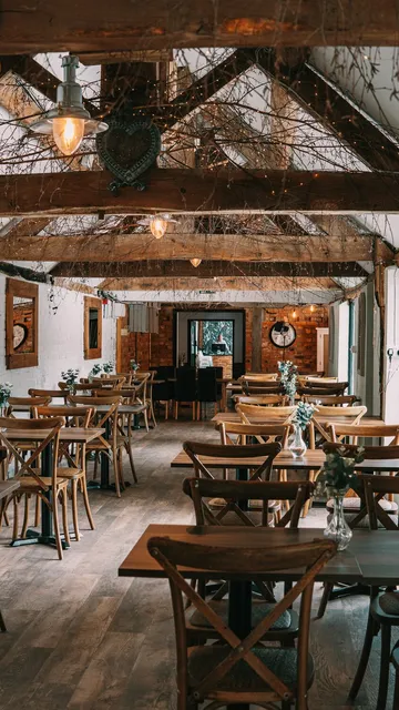 The Roost set with wooden tables beneath the beams