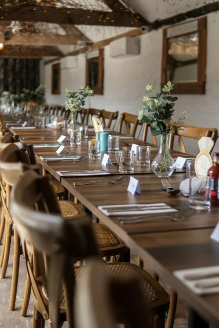 Place settings and greenery running down the long table at The Roost