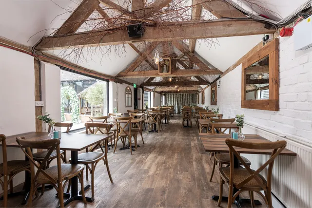 The Roost with its high beamed ceiling and garden windows
