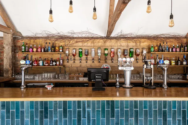 The Roost's bar with pendant bulbs above