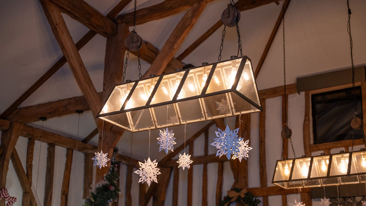 Inside The Rooster restaurant with exposed beams and fairy lights
