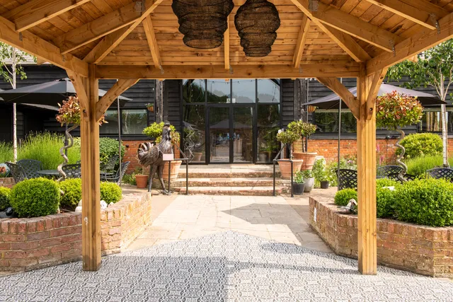 Looking through the oak pergola to The Rooster's glazed entrance
