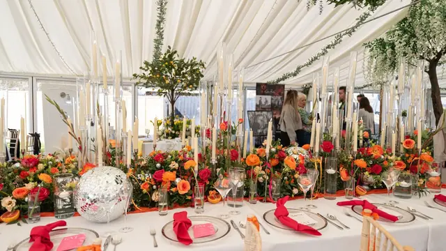 A long table dressed with flowers for the wedding breakfast