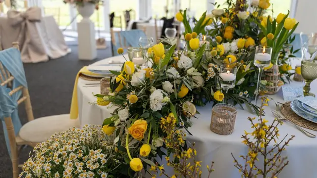 A bright table setting with seasonal flowers