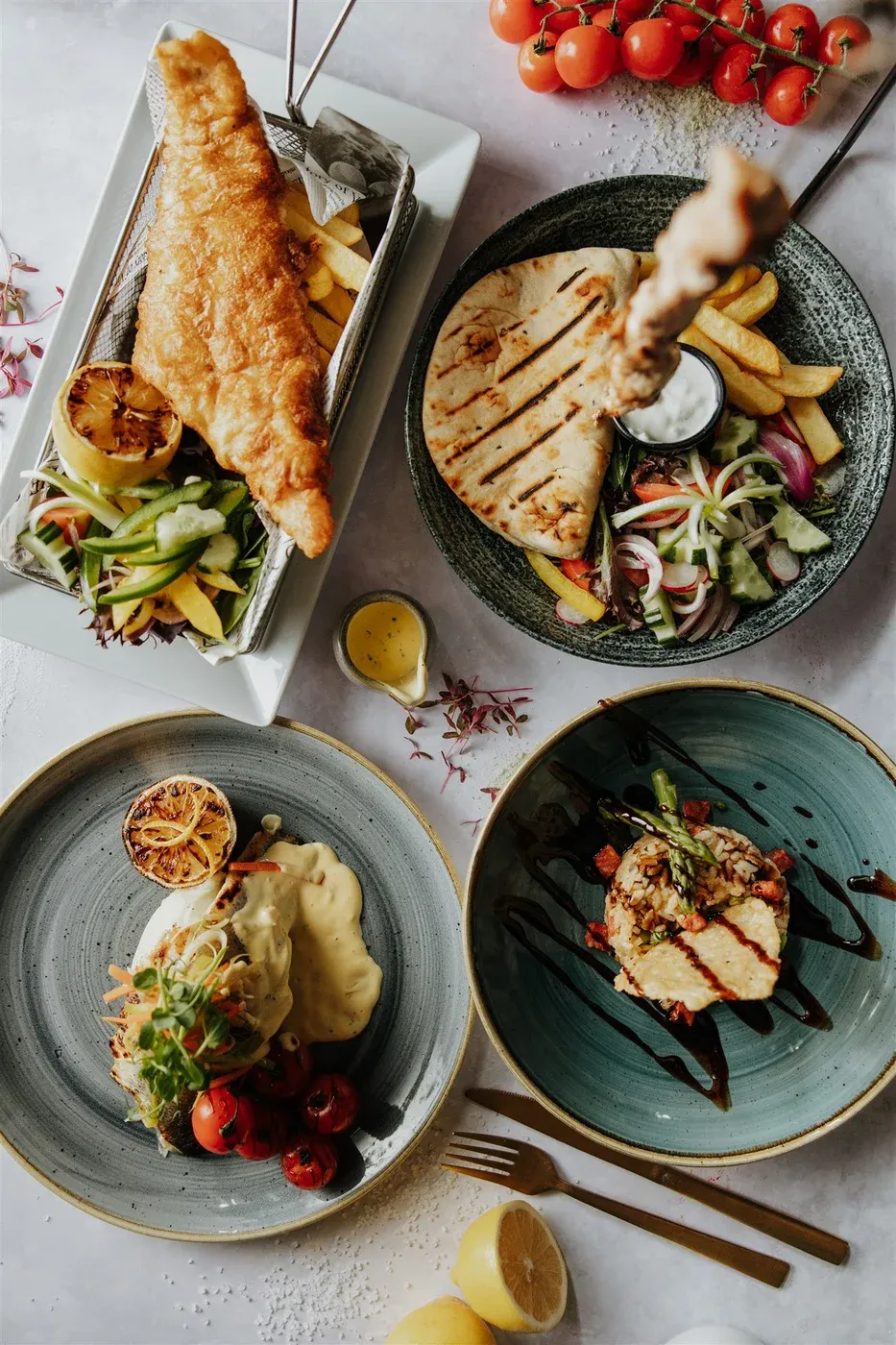 An overhead spread of dishes at The Rooster restaurant