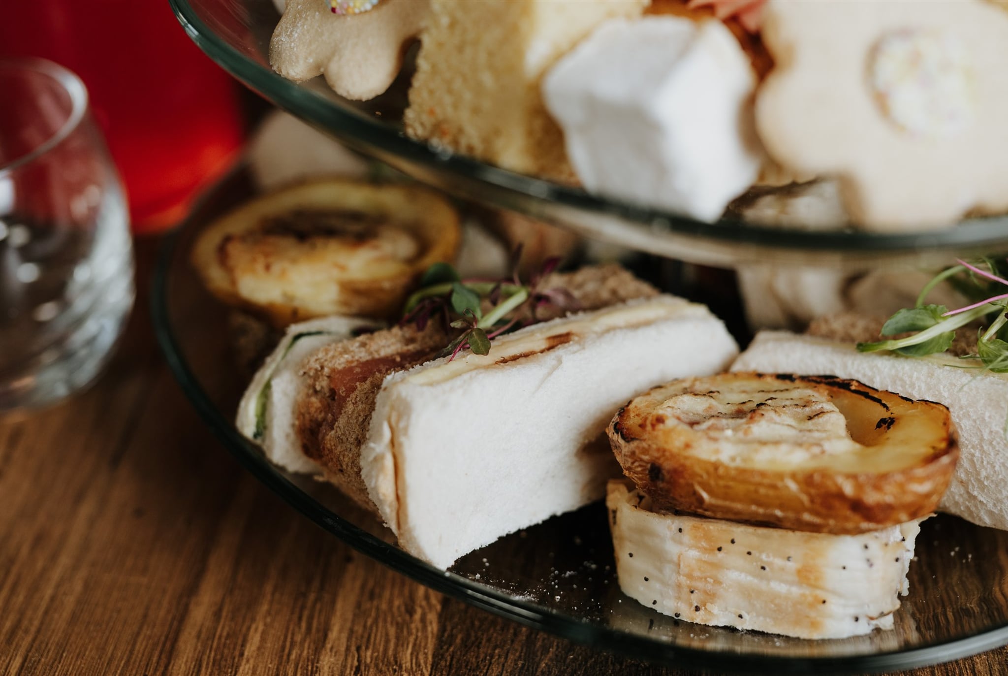 The savoury tier of an afternoon tea at The BarnYard, with sausage wellington and potato skins