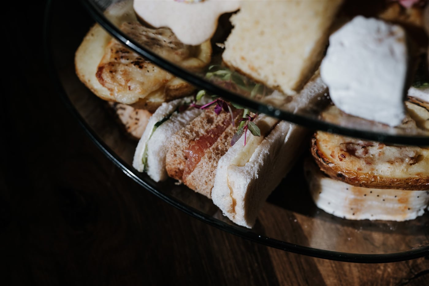 The savoury tier of an afternoon tea at The BarnYard, with sausage wellington and finger sandwiches