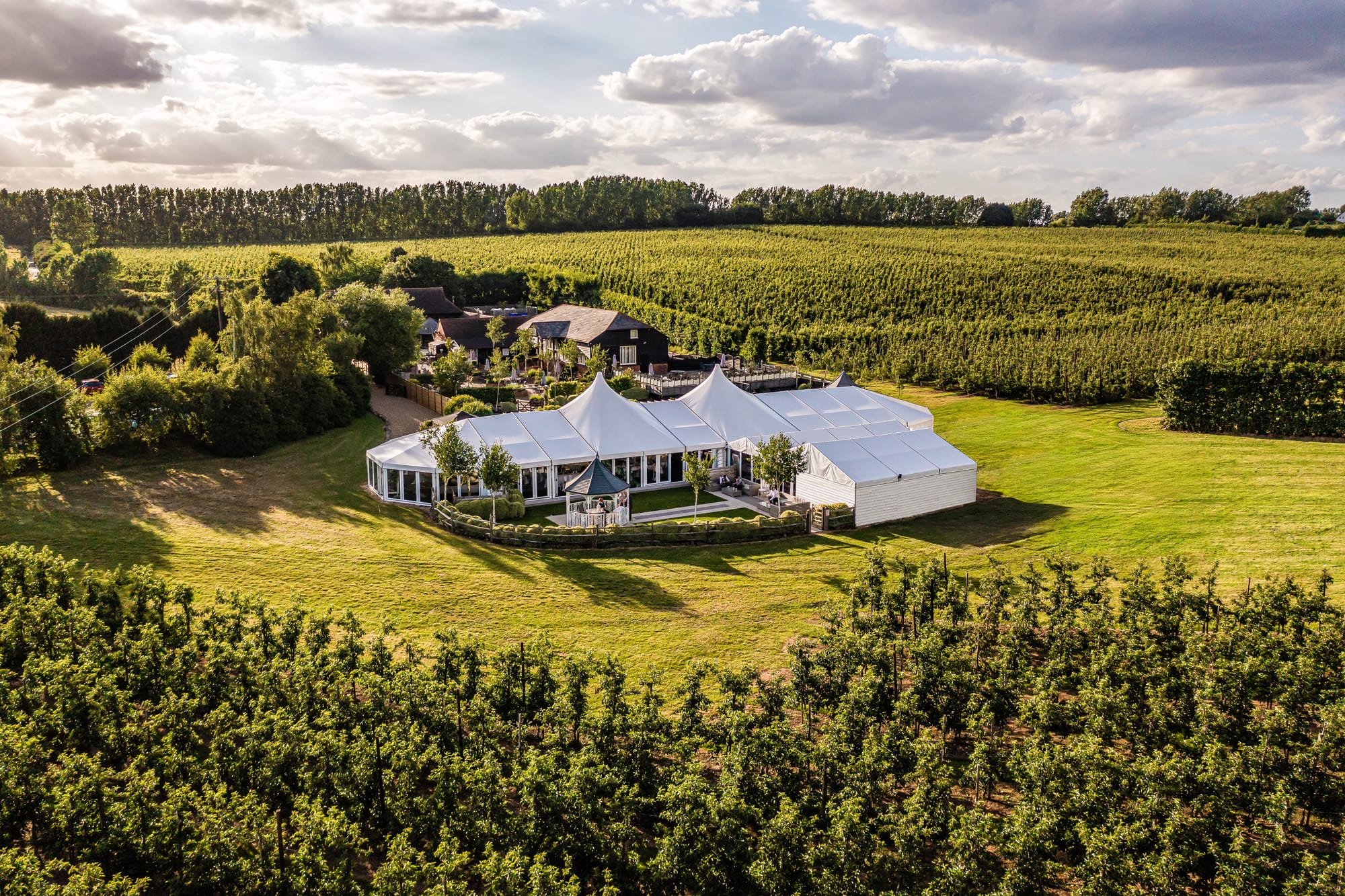 Aerial view of The BarnYard at Upchurch, surrounded by apple orchards and open Kent countryside