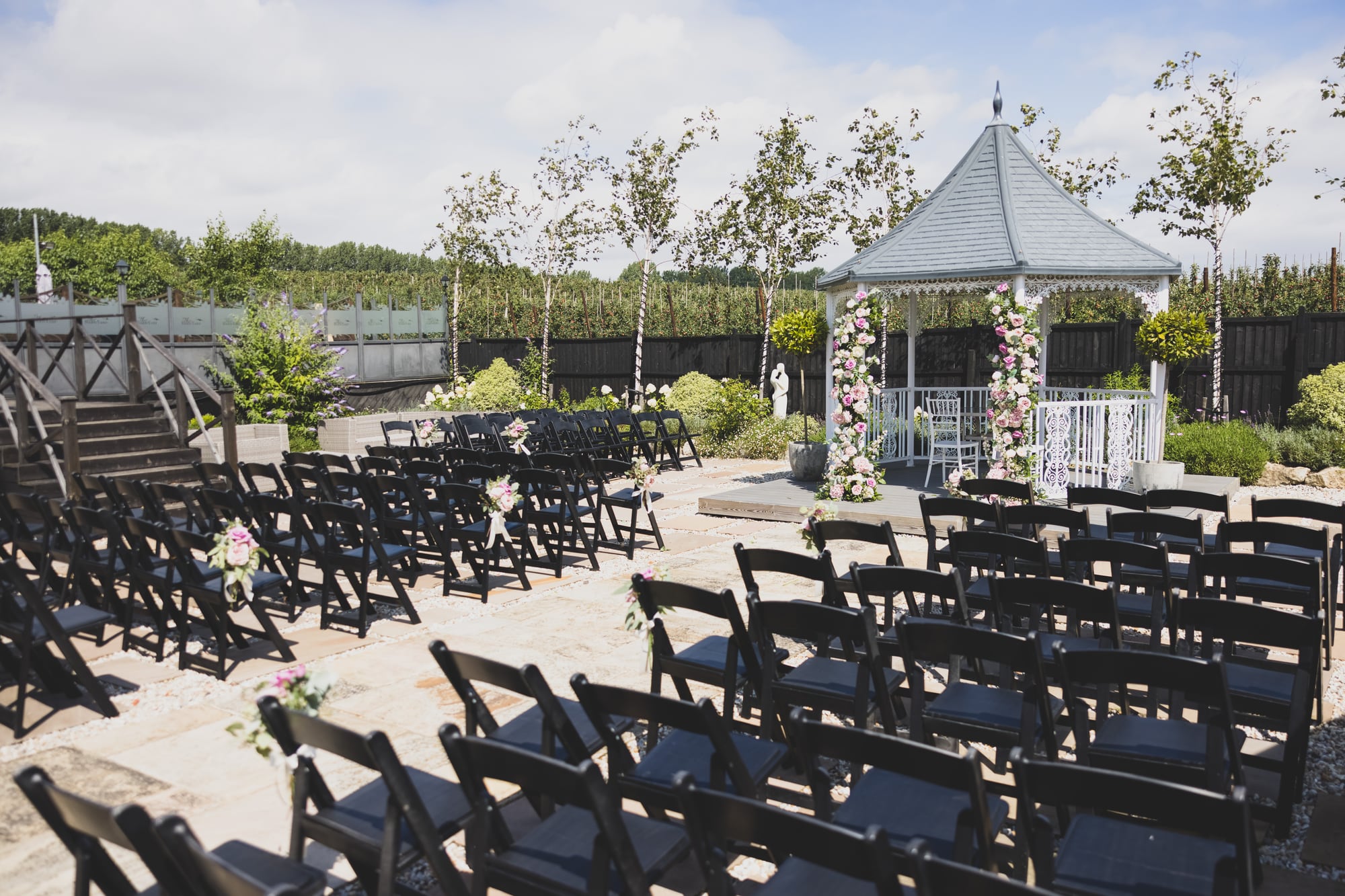 Chairs set out facing the ceremony gazebo at The BarnYard, with lavender in the foreground