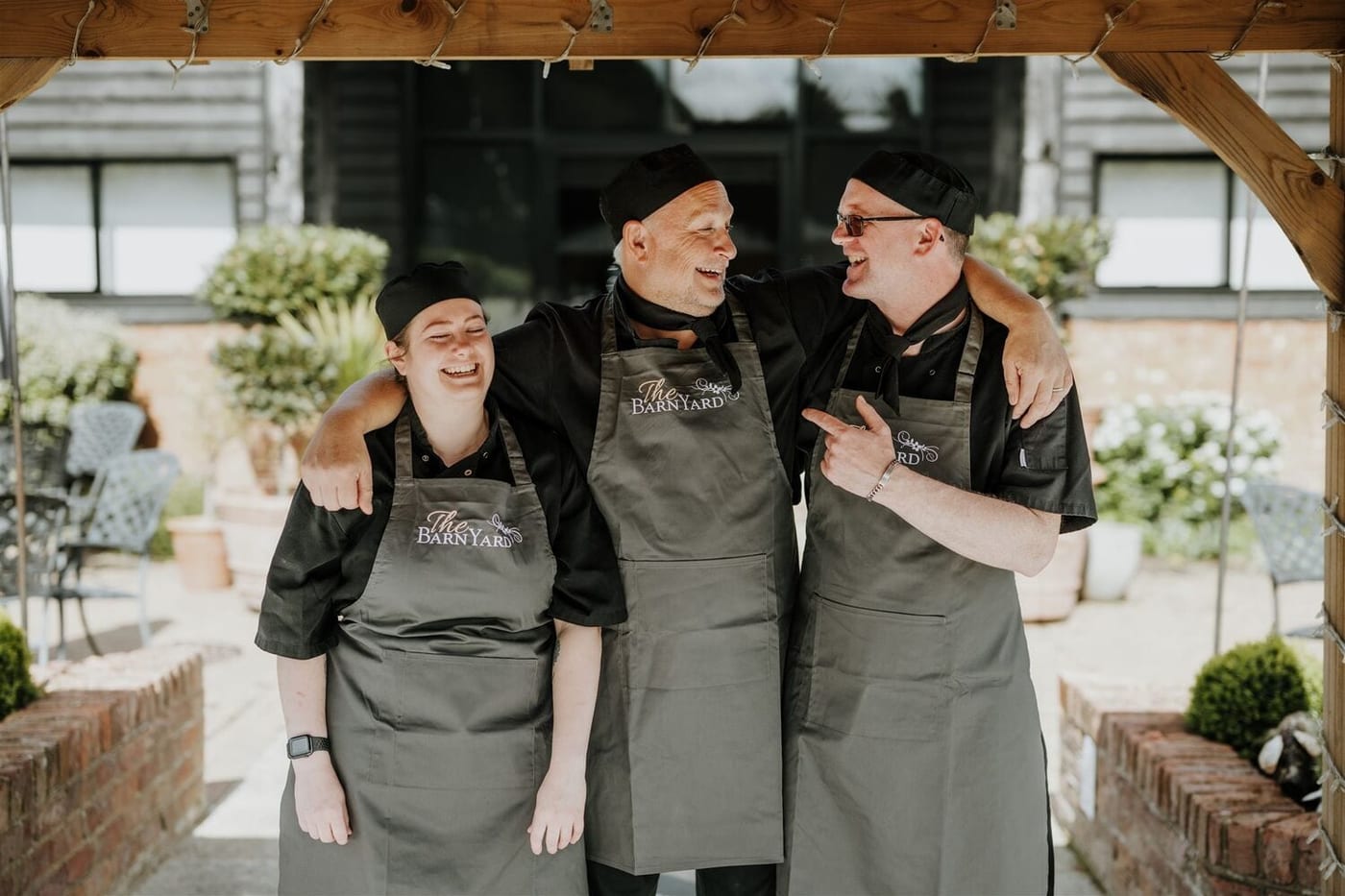Three chefs from The BarnYard kitchen team standing outside the restaurant