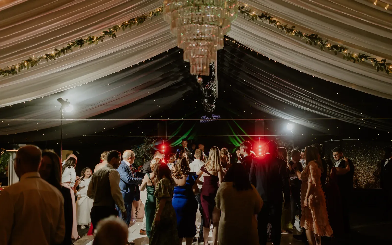 A packed dance floor at a celebration at The BarnYard