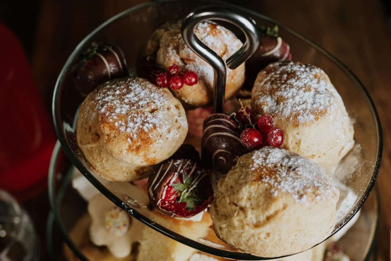 A tiered afternoon tea stand of sandwiches, scones and cakes at The BarnYard