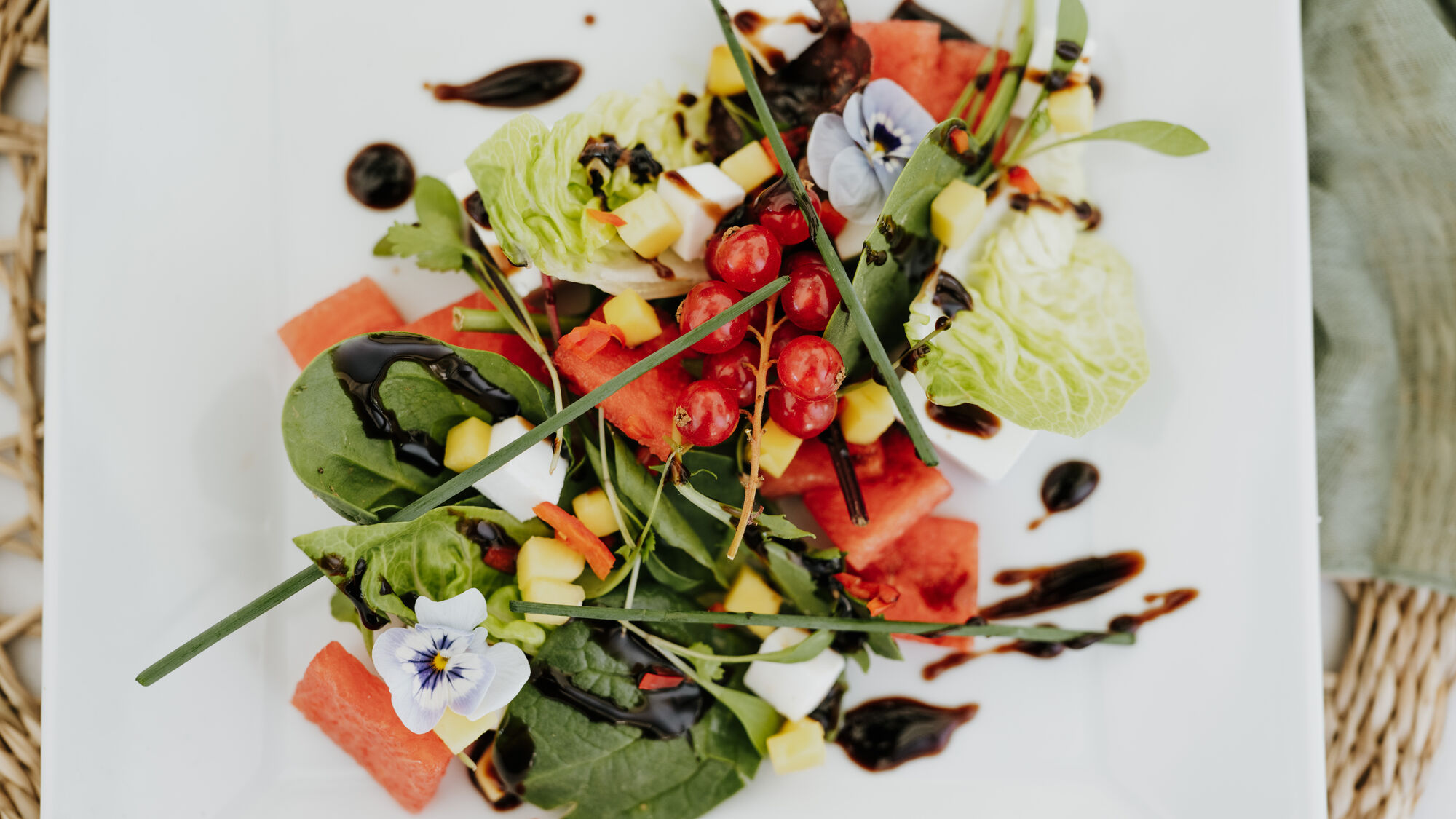 A watermelon, feta and leaf salad dressed with balsamic, plated at The BarnYard