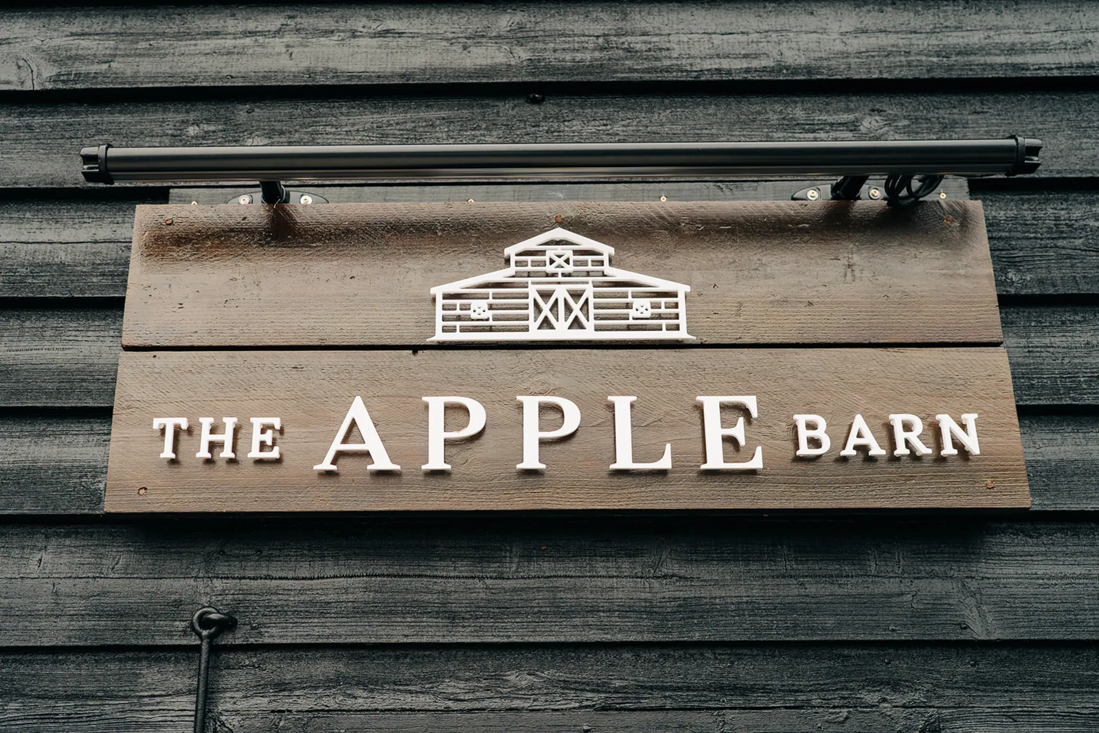 The hand-painted Apple Barn sign on the weatherboard barn at The BarnYard
