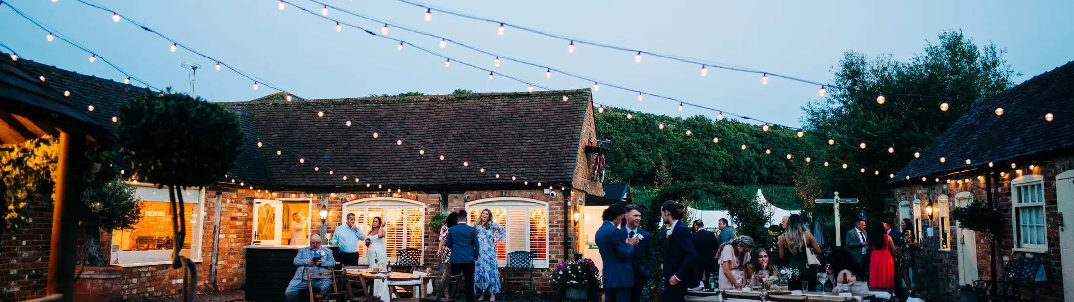 A couple at their twilight wedding at The BarnYard