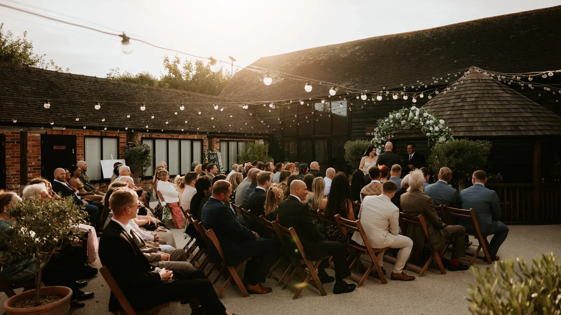 Couple exchanging vows at twilight at The BarnYard, Kent