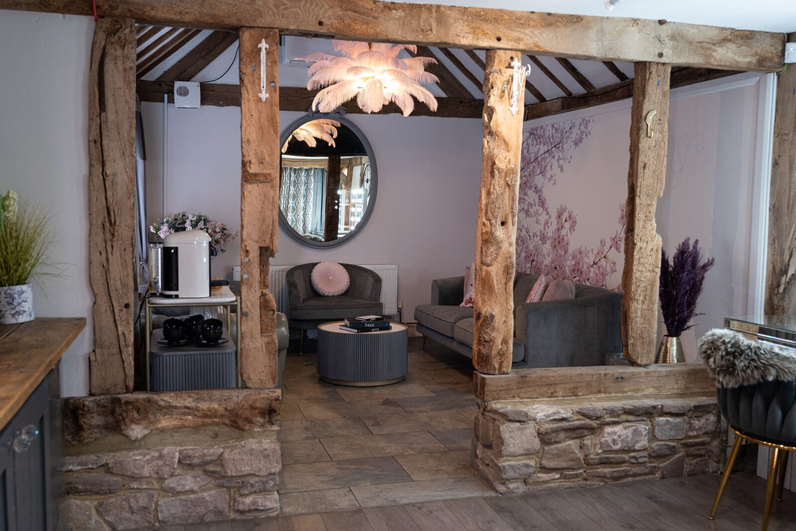 The Blossom bridal suite at The BarnYard, with rustic oak beams, an LED getting-ready station and soft pink seating
